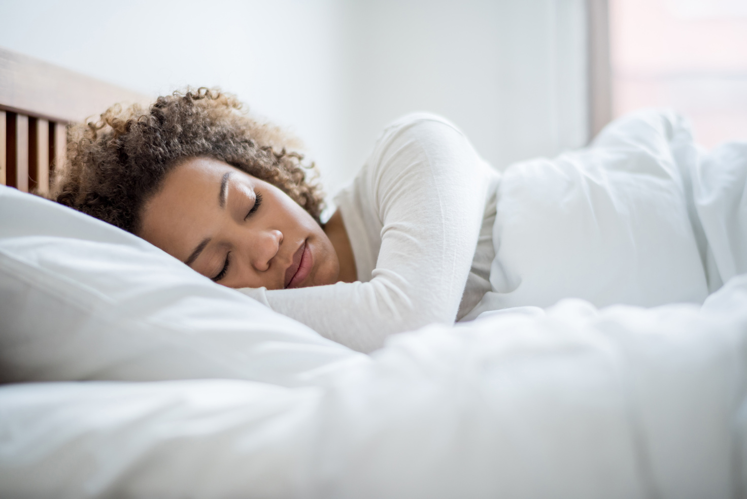 Black woman sleeping in bed