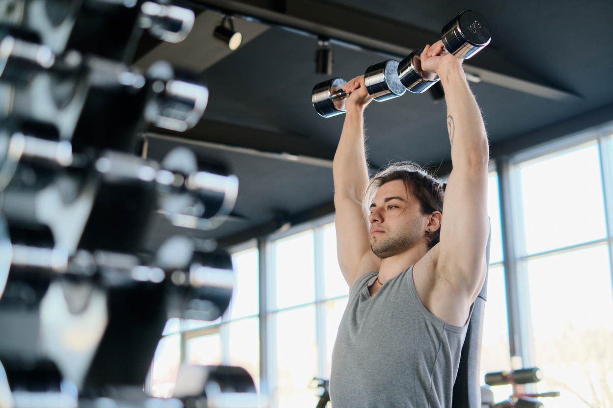 Man Exercising with Dumbbells